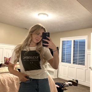 Square graphic T with white lettering. Super fun to wear under Jean jacket